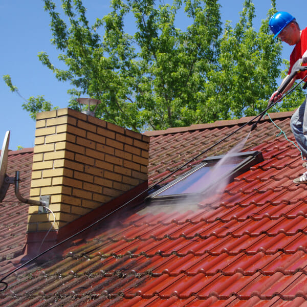 Tile roof being cleaned with a pressure washer